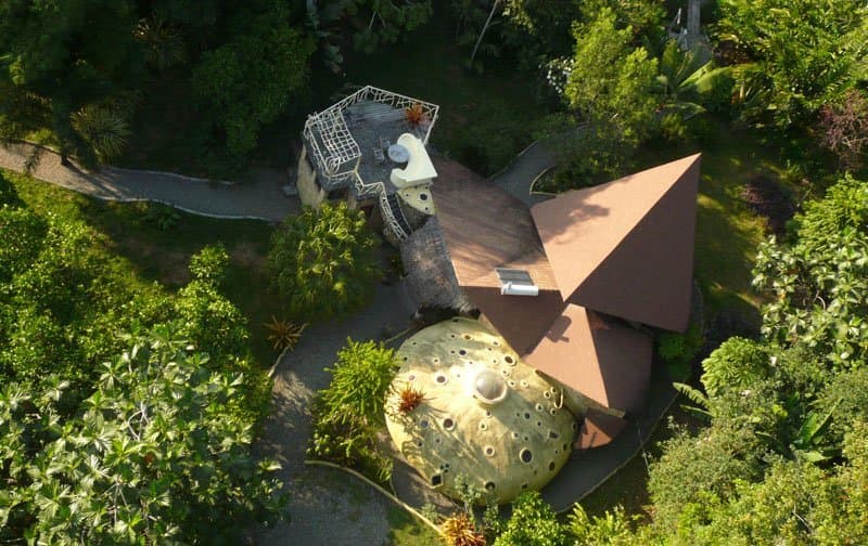 Aerial view of Tree House Lodge — the Beach Suite's gold mosaic dome and thatched rancho nestled inside the 10-acre botanical garden